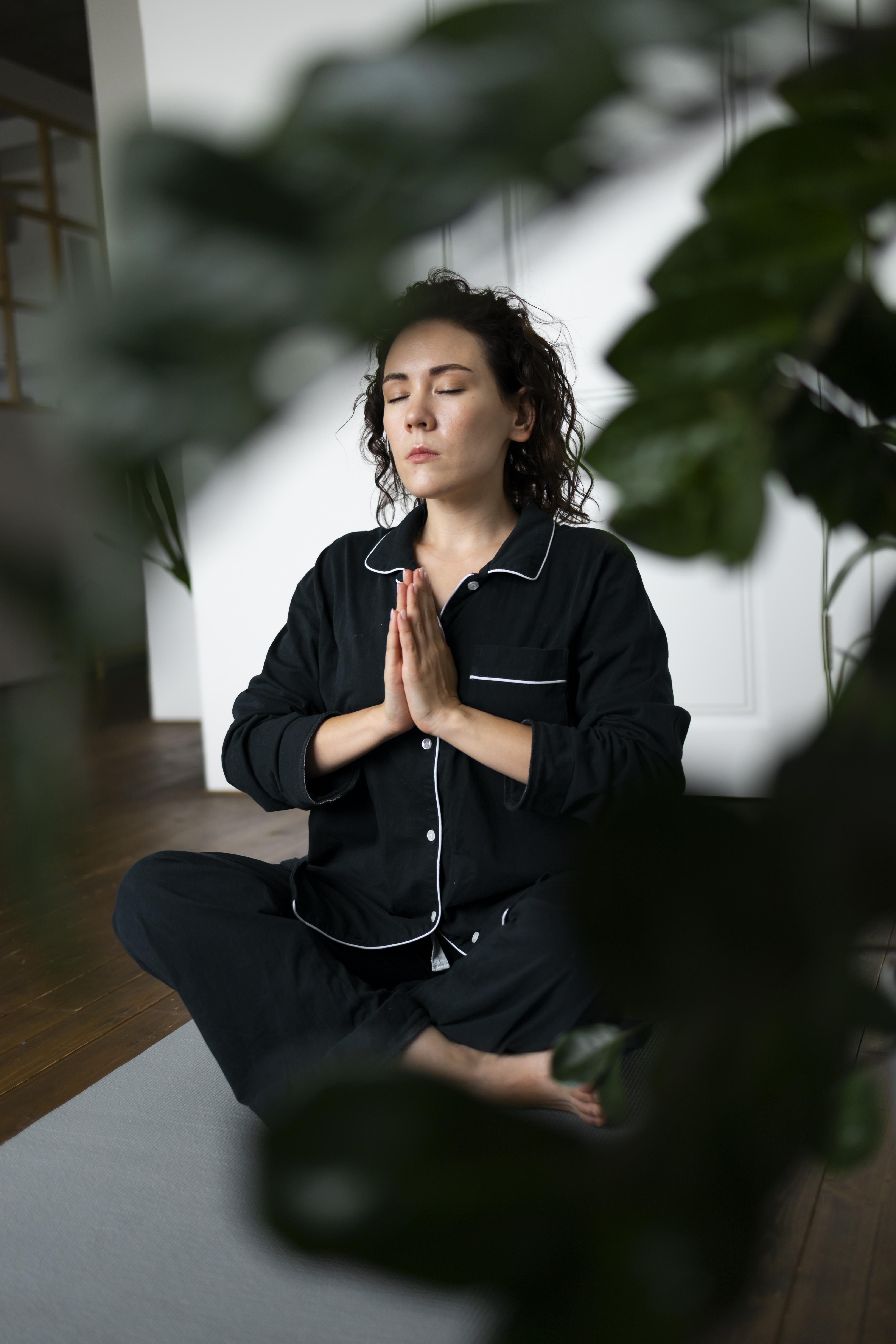 full-shot-woman-meditating-mat.jpg