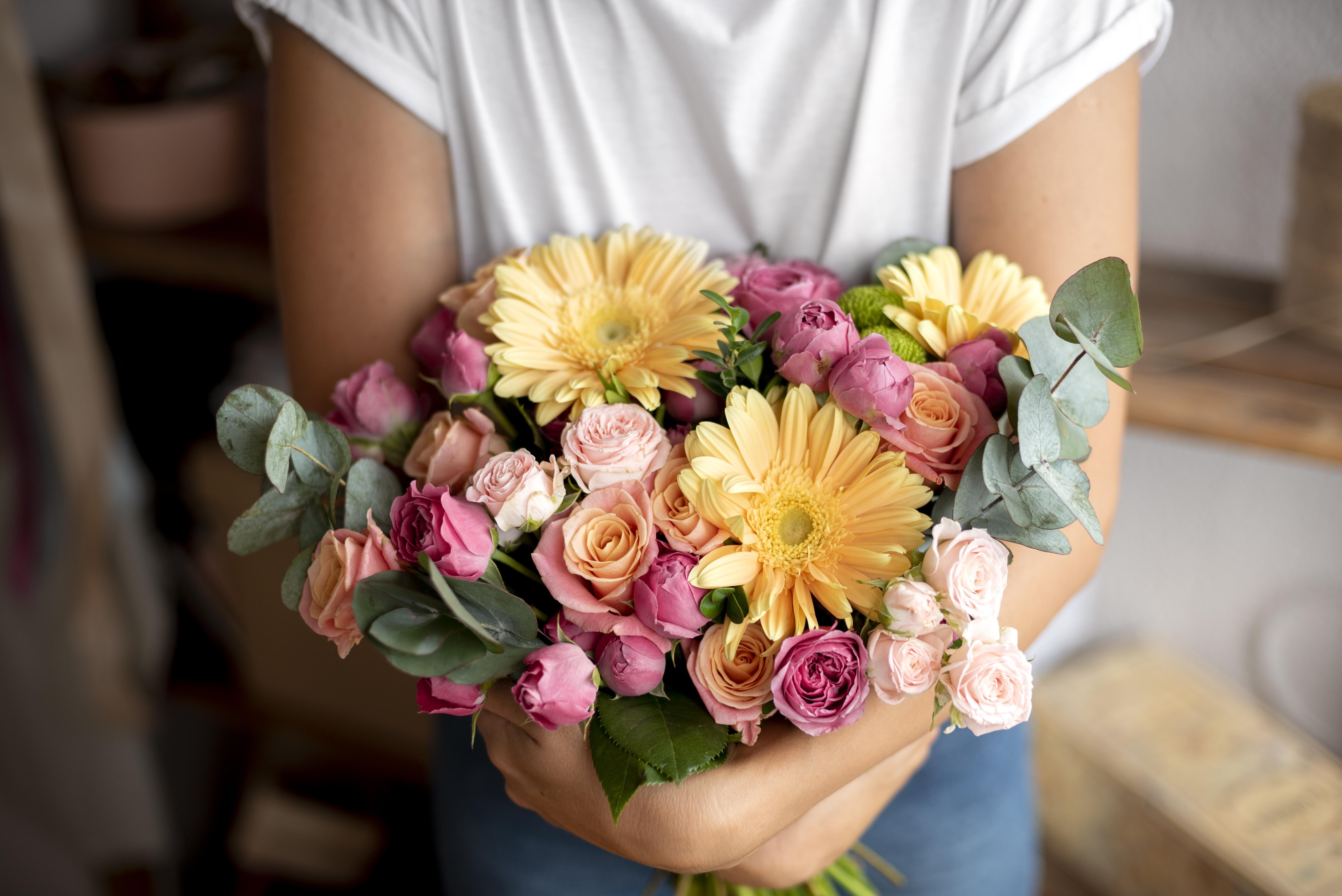 close-up-hands-holding-flowers-bouquet.jpg
