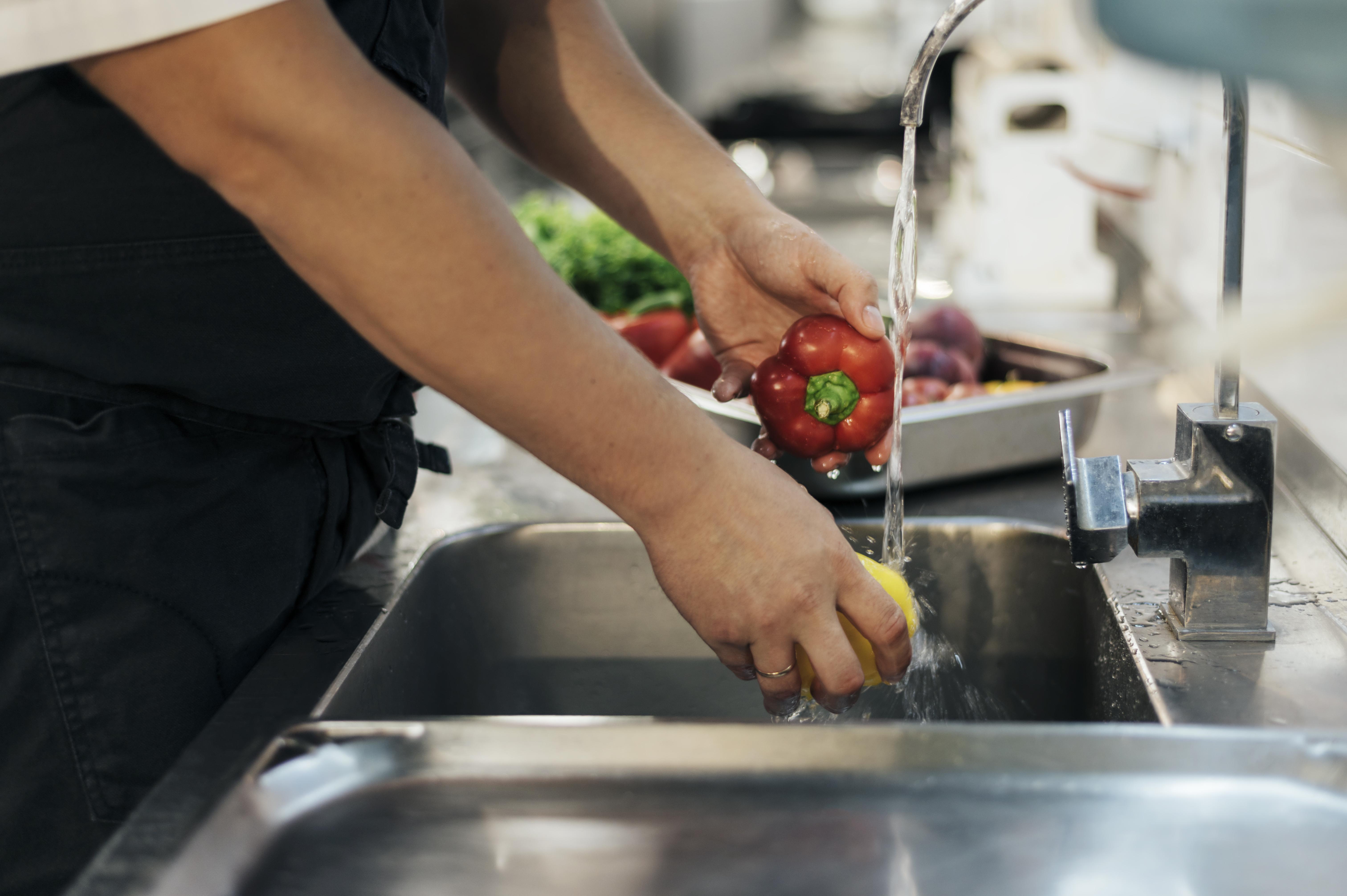 side-view-male-chef-washing-vegetables.jpg