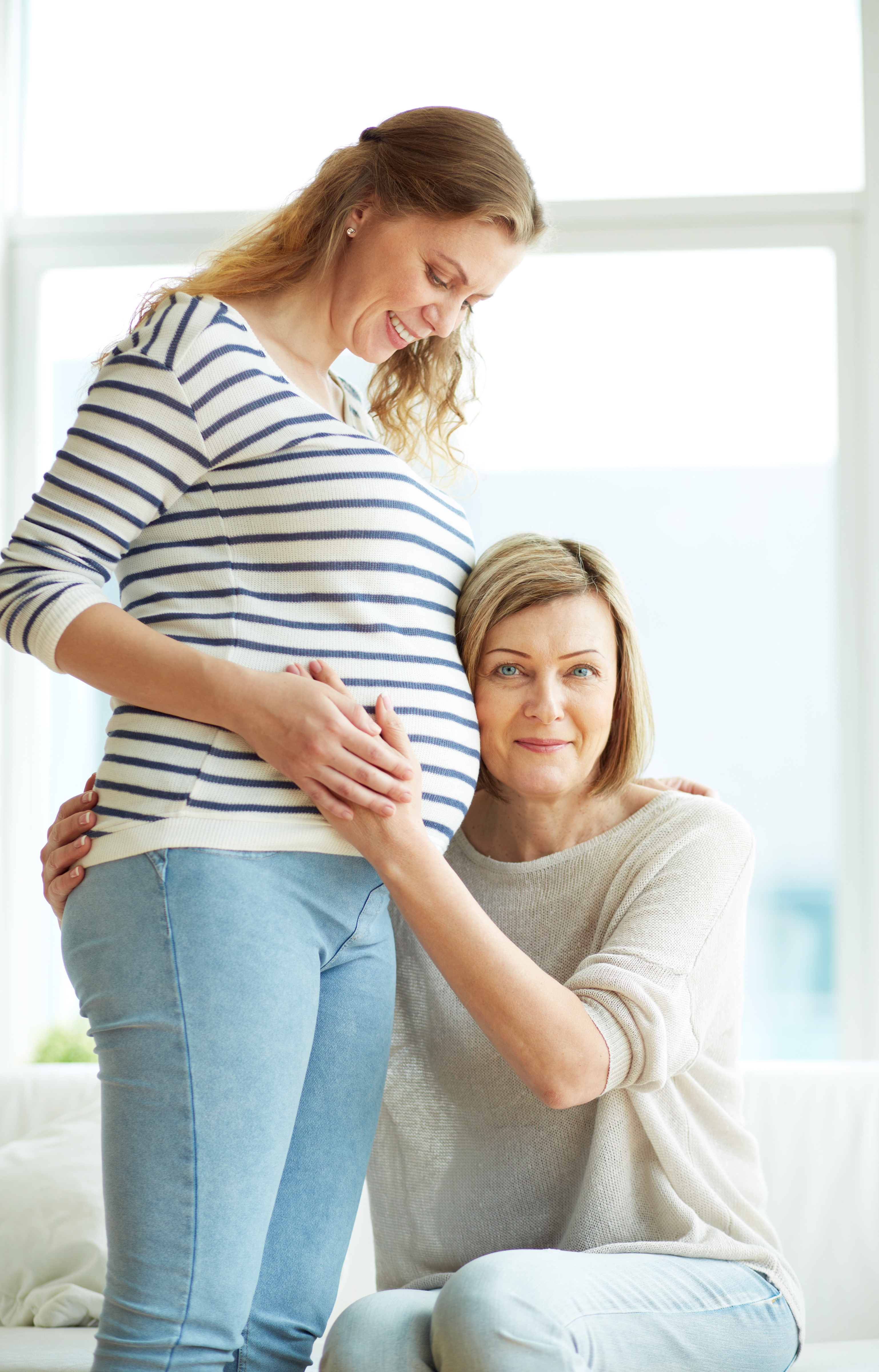 happy-grandmother-holding-belly-pregnant-woman.jpg