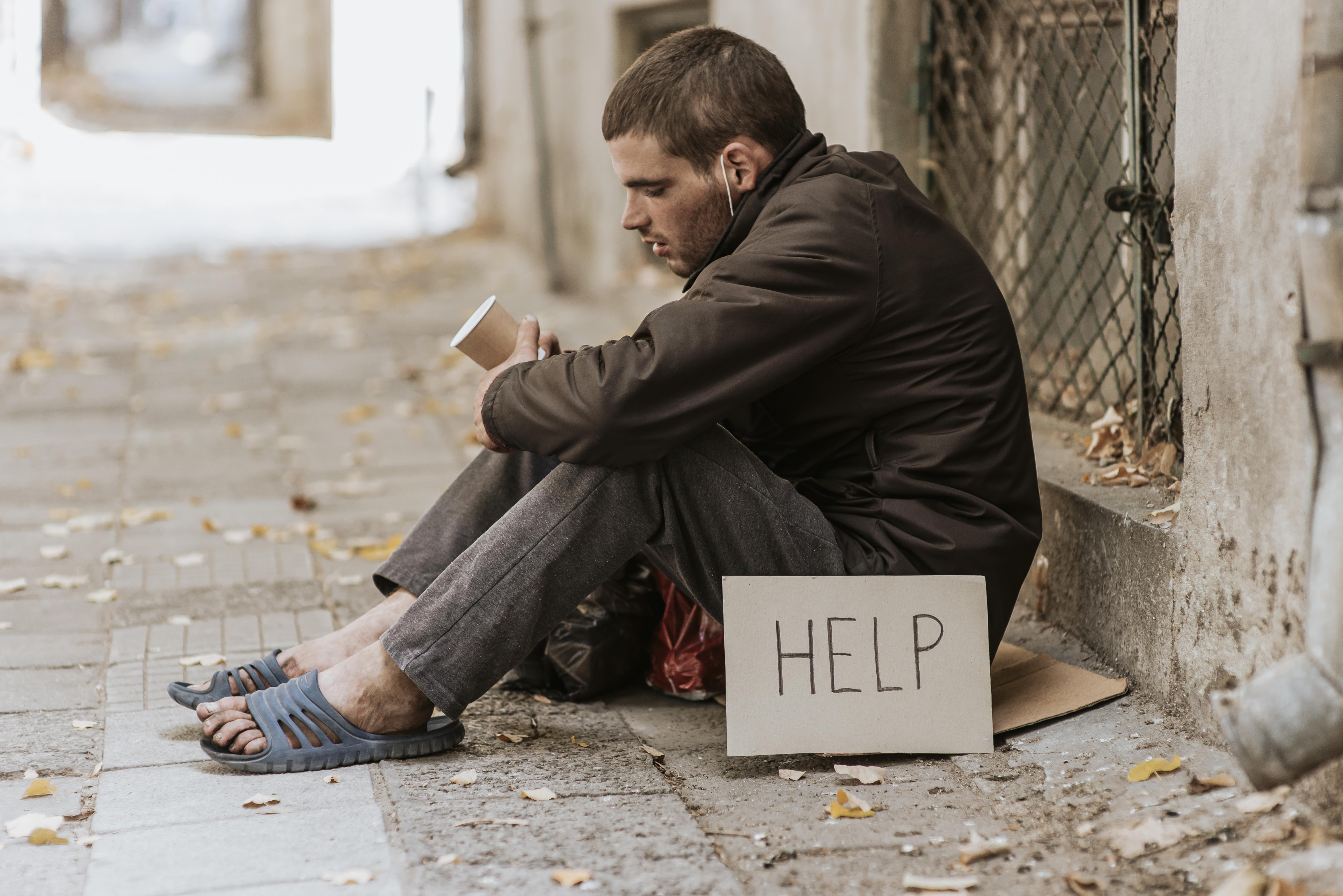 homeless-man-street-with-cup-help-sign.jpg